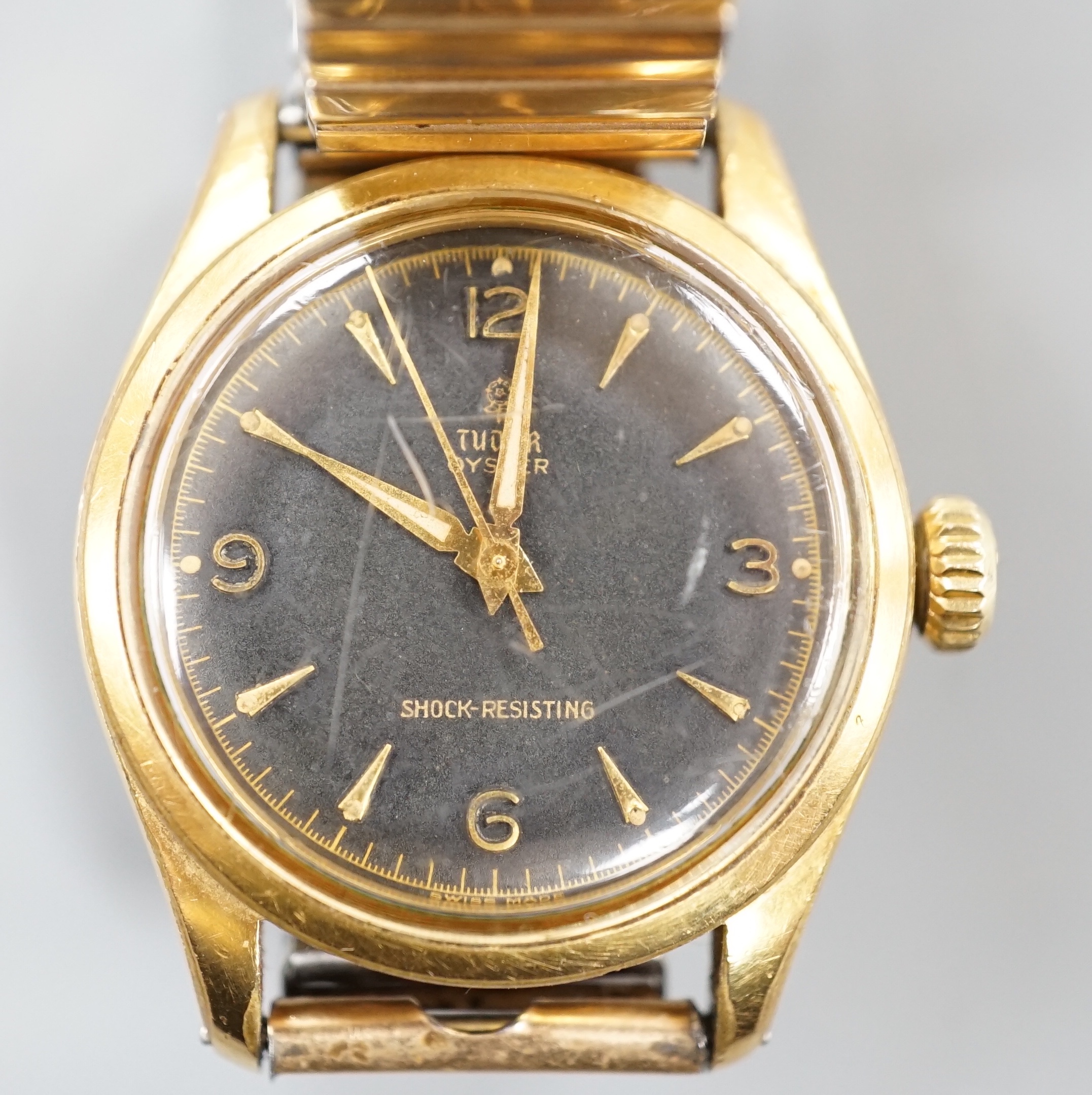 A gentleman's 1950's? mid-size steel and gold plated Tudor Oyster manual wind wrist watch, with black dial and associated strap, case diameter 33mm, no box or papers.